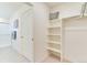 Spacious walk-in closet featuring custom shelving, providing ample storage solutions and organization at 22315 E 6Th Ave, Aurora, CO 80018