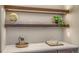 Stylish bar area featuring quartz countertops, custom wood cabinets, and floating shelves with lights at 12628 N 3Rd St, Parker, CO 80134