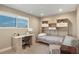 This bedroom features a built-in storage bed and desk with a large window and neutral decor at 12628 N 3Rd St, Parker, CO 80134