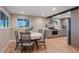 Bright dining area adjacent to a modern kitchen boasts natural light and stylish finishes at 12628 N 3Rd St, Parker, CO 80134