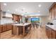 Open concept kitchen with island, modern appliances, and hardwood floors at 12628 N 3Rd St, Parker, CO 80134