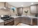 Modern kitchen with stainless steel appliances, stylish countertops, and sleek cabinetry at 12628 N 3Rd St, Parker, CO 80134