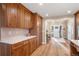 Charming kitchen featuring light wood cabinets, quartz countertops and hardwood floors at 12628 N 3Rd St, Parker, CO 80134