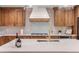 Modern kitchen features white tile, wood cabinets, and gold faucet at 12628 N 3Rd St, Parker, CO 80134