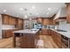 Modern kitchen with custom wood cabinets, a large island, and stainless steel appliances at 12628 N 3Rd St, Parker, CO 80134