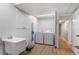 Well-lit laundry room featuring a utility sink, cabinets, and modern washer and dryer at 12628 N 3Rd St, Parker, CO 80134
