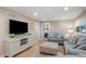 Comfortable living room with large TV, neutral paint, bright light and stylish furniture at 12628 N 3Rd St, Parker, CO 80134
