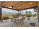 Outdoor patio with a wooden beam roof, stone floor and gas grill perfect for entertaining at 12628 N 3Rd St, Parker, CO 80134