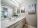 View of double sinks and a large mirror and artwork in a well-lit bathroom at 9911 E Idaho Cir # 202, Denver, CO 80247