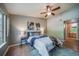 Comfortable bedroom with hardwood floors, a ceiling fan, and ensuite bath access at 9911 E Idaho Cir # 202, Denver, CO 80247