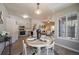 Open-concept dining room featuring wood floors, a round table, and an adjacent kitchen at 9911 E Idaho Cir # 202, Denver, CO 80247