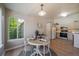 Bright dining area with a round table, wood floors, and views of the adjacent kitchen at 9911 E Idaho Cir # 202, Denver, CO 80247