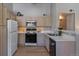 Bright kitchen with white cabinets, stainless steel appliances, and a breakfast bar at 9911 E Idaho Cir # 202, Denver, CO 80247