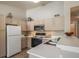 Bright kitchen with white cabinets, stainless steel appliances, and plenty of counter space at 9911 E Idaho Cir # 202, Denver, CO 80247