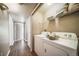 Functional laundry room with side by side washer and dryer and wire shelving at 9911 E Idaho Cir # 202, Denver, CO 80247