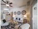 Cozy living room featuring hardwood floors, a ceiling fan, and an open connection to the kitchen at 9911 E Idaho Cir # 202, Denver, CO 80247