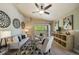 Well-decorated living room with hardwood floors, ceiling fan, and balcony access at 9911 E Idaho Cir # 202, Denver, CO 80247