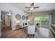 Bright living room with hardwood floors, a ceiling fan, and a sliding glass door to the balcony at 9911 E Idaho Cir # 202, Denver, CO 80247