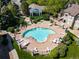 Aerial view of community pool with lounge chairs and well-manicured landscaping at 9911 E Idaho Cir # 202, Denver, CO 80247