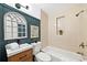 Stylish bathroom featuring a dark green accent wall, modern fixtures, and tiled shower at 1380 Magnolia St, Denver, CO 80220