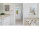 Bright bathroom featuring white cabinetry, tiled accents, and a separate shower area at 1380 Magnolia St, Denver, CO 80220