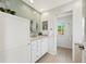 Well-lit bathroom with modern fixtures, tiled floor, and vanity with marble countertop at 1380 Magnolia St, Denver, CO 80220