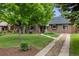 Beautiful home surrounded by mature trees and lush landscaping, offering a serene setting at 1380 Magnolia St, Denver, CO 80220