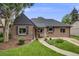 Charming brick home featuring a manicured lawn, mature trees, and inviting curb appeal at 1380 Magnolia St, Denver, CO 80220
