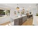 Contemporary kitchen with large island, stainless steel appliances, and a seamless flow to the dining area at 1380 Magnolia St, Denver, CO 80220