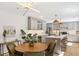 Stylish kitchen and dining area with modern lighting, updated cabinets, and a large island at 1380 Magnolia St, Denver, CO 80220