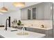 Updated kitchen featuring gray cabinets, quartz countertops, subway tile backsplash, and modern pendant lighting at 1380 Magnolia St, Denver, CO 80220