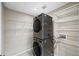 Efficient laundry room with stacked washer/dryer and ample shelving for storage at 1380 Magnolia St, Denver, CO 80220