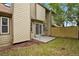 Backyard features a private patio, wooden fence, grass, and sliding glass door access at 15323 E Louisiana Ave, Aurora, CO 80017