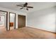Neutral bedroom with closet space, carpet flooring, and adjacent bathroom at 15323 E Louisiana Ave, Aurora, CO 80017