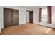 Bedroom with carpet floors, closet doors, and a window at 15323 E Louisiana Ave, Aurora, CO 80017