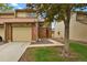Charming townhome features a brick facade, attached garage, and well-maintained landscaping at 15323 E Louisiana Ave, Aurora, CO 80017