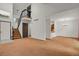 Open-concept living area with staircase and view of the kitchen at 15323 E Louisiana Ave, Aurora, CO 80017