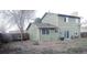 View of home's backyard with mature trees and patio at 9852 W 76Th Ave, Arvada, CO 80005