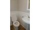 Powder room featuring a pedestal sink, toilet and tile floor at 9852 W 76Th Ave, Arvada, CO 80005