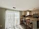 Open kitchen with breakfast bar, stainless appliances, and bright natural light at 9852 W 76Th Ave, Arvada, CO 80005
