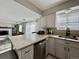 Bright kitchen featuring stainless steel appliances, stone countertops, and updated cabinetry at 9852 W 76Th Ave, Arvada, CO 80005