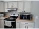 Well-equipped kitchen featuring modern appliances and quartz countertops at 9852 W 76Th Ave, Arvada, CO 80005