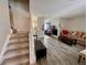 Open-concept living room with staircase and modern flooring at 9852 W 76Th Ave, Arvada, CO 80005