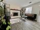 Cozy living room with a fireplace, shelving, and natural light from the window at 9852 W 76Th Ave, Arvada, CO 80005