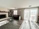 Sun-filled living room with a fireplace, hardwood floors, and sliding glass door at 9852 W 76Th Ave, Arvada, CO 80005