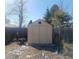 A backyard shed provides extra storage space, with a small window and double-door access at 9852 W 76Th Ave, Arvada, CO 80005