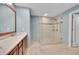 Modern bathroom with a glass walk-in shower, single vanity with granite countertop, and tiled flooring at 8300 Fairmount Dr # Ff104, Denver, CO 80247