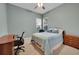 Bedroom featuring a window with shutters, ceiling fan, carpet, and a wooden desk and dresser at 8300 Fairmount Dr # Ff104, Denver, CO 80247