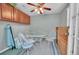 Bright dining area with a round glass table, seating for four, and a ceiling fan at 8300 Fairmount Dr # Ff104, Denver, CO 80247