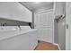 Bright laundry room featuring a washer, dryer and white cabinets at 8300 Fairmount Dr # Ff104, Denver, CO 80247